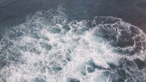 Aerial look down on foam from a wave disappearing in the ocean Stock Footage 71289043