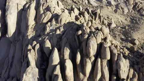 Aerial look down transitioning to look up reveal of interesting rock formatio Stock Footage 155653433