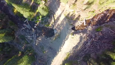 Aerial looking down over damage from forest fire to river, now filled with large Stock Footage 162916635