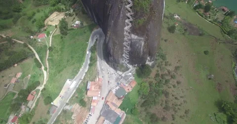 Aerial looking down over the Piedra del Penol of Guatape Видео 65632347