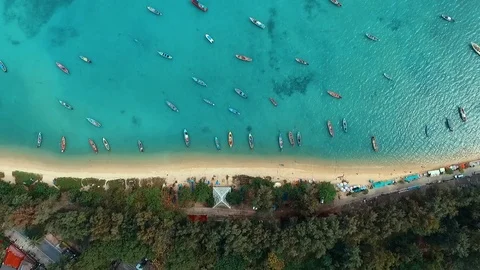 Aerial: Looking down at the Rawai beach with long tail boats. Stock Footage 69903909