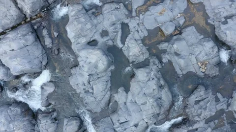 Aerial looking down at river through rocks 스톡 동영상 111582384