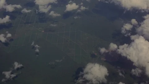 Aerial looking down through clouds at grid-like agricultural field irrigation 스톡 동영상 101302461