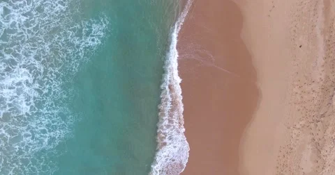 Aerial Looking down on waves breaking Stock Footage