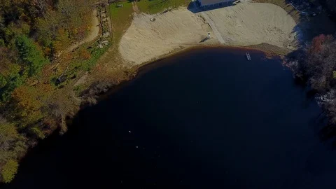 Aerial looking straight down on empty beachfront in New England during fall Video stock 98009350