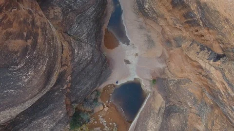 Aerial looking straight down over a red rock steep canyon Stock Footage 92604878