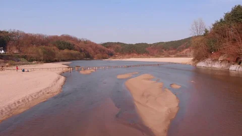 Aerial low altitude takeover of tiny wooden bridge above the river Stock Footage 110959250
