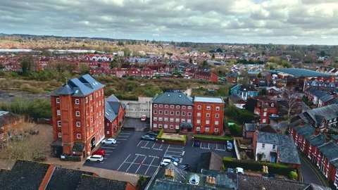 Aerial low angle drone flyover of English suburb village town romsey at sunset Stock Footage 332373290
