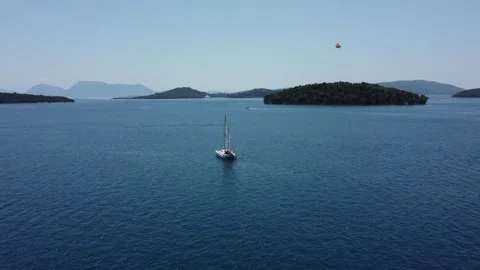 Aerial low angle drone view of sail boat heading out to open seas Stock Footage 245604816