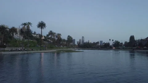 Aerial Low Angle of Echo Park Lake to Reveal of Los Angeles Skyline 库存影片 210538585