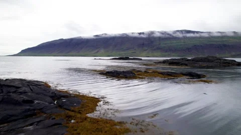 Aerial Low Angle Flight West Fjords Beach Small Islands with Mountains Stock Footage 258481390