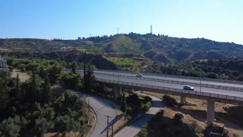 Aerial low angle view of highway bridge with traffic under blue sky Stock Footage 343961664