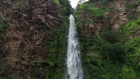 Aerial low-angle view of the massive Wli Falls cascading down rocky cliffs Stock-Footage 330912121