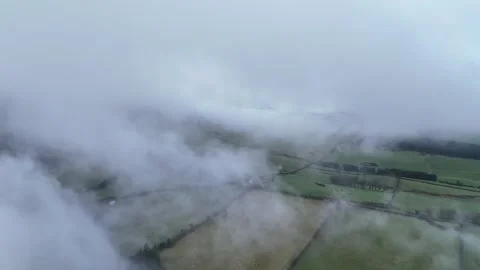 Aerial Low Cloud Over Green Farmland Countryside in 4K 60fps Stock Footage 332567332