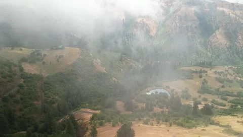 Aerial of low clouds above mountains in White Bird Idaho in summer Stock Footage 281536727