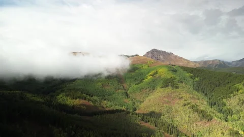 Aerial of low clouds on Crested Butte Colorado Elk Mountain range in late summer Stock Footage 250930542