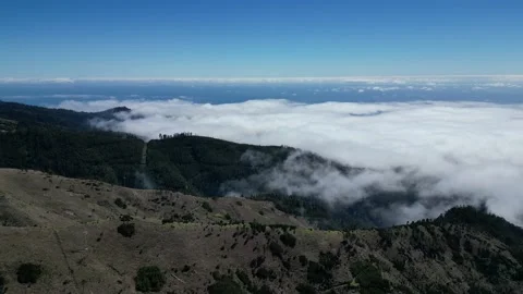 Aerial of low clouds floating over the mountains on Madeira Island in Portugal Stock Footage 238391323