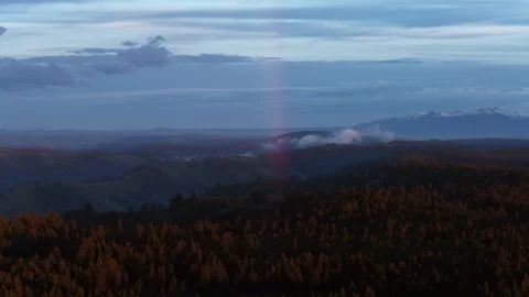 Aerial low clouds over Wallowa Mountains in Oregon at blue hour dramatic sky Video stock 335841887