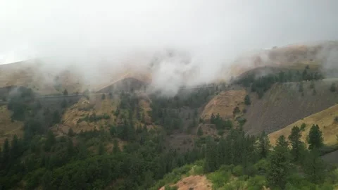 Aerial of low clouds at White Bird Hill in Idaho along Highway 95 in summer Stock Footage 281537335
