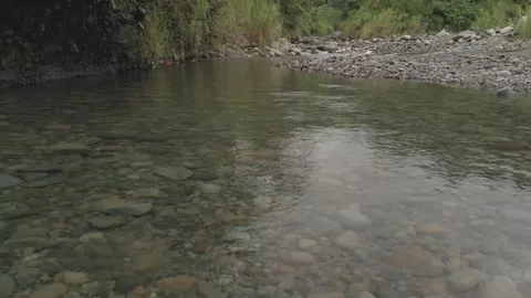 Aerial. A low drone view of a shallow river flowing. HD Video stock 139065141