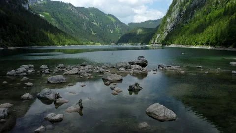 Aerial low fly over rocks and Gosausee lake in Upper Austria Stock Footage 137876908