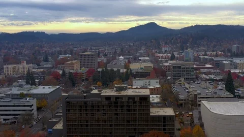 Aerial low flying over Eugene Oregon at sunset urban city view Stock Footage 120394499