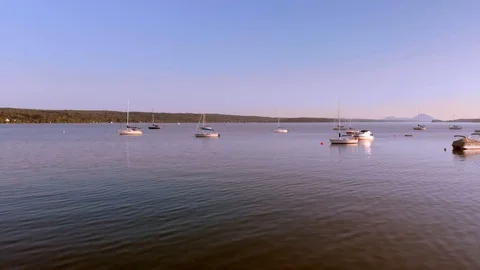 Aerial low forward, between small boats at anchor in calm lake Quebec, 4k Stock Footage 97486173