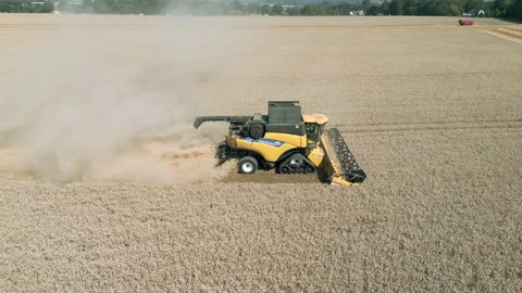 Aerial low level parallel tracking view clip of a combine harvester harvesting Stock-Footage 205330161