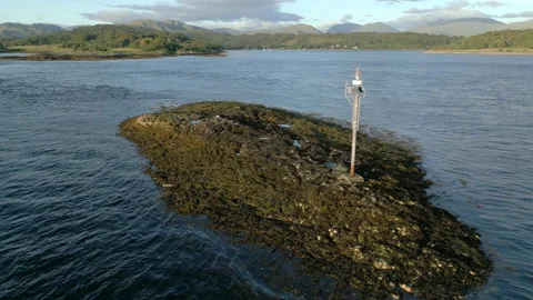 Aerial, low orbit of small auto light beacon, Isle of Eriska, Scotland Stock Footage 204925884