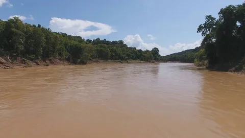 Aerial low over mud river Laos Stock Footage 77808526
