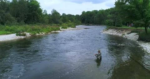 Aerial Low Pass Over Of Fly Fisherman Holding his Rod Out In The Flowing River Stock Footage 185561804