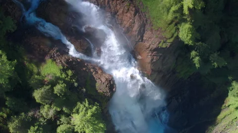 AERIAL LOWERING ROTATING to a dramatic waterfall in Switzerland, Iffigfall Stock Footage 146583411