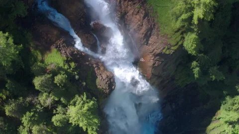 AERIAL LOWERING ZOOM OUT to a dramatic waterfall in Switzerland, Iffigfall Stock Footage 146583308