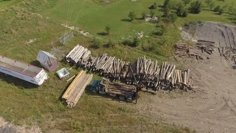 Aerial lumber yard crane moving log onto truck 4k Stock Footage