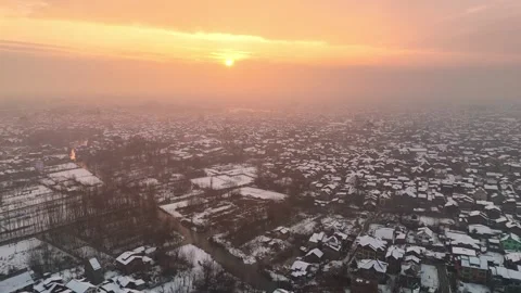 Aerial magic: Sunset over snow-covered homes in kashmir city Stock Footage 310224819