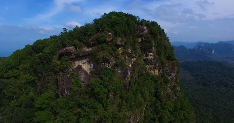Aerial: Man controls drone sitting on a rock view point on the mountain. Stock Footage 71195960