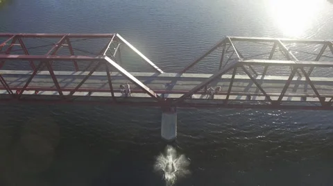 Aerial of Man Diving off Abandoned Red Bridge Stock Footage 65077585