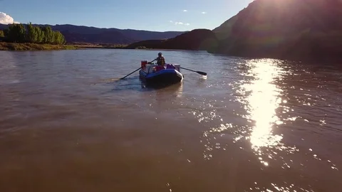 Aerial of man floating down the beautiful desert colorado river Stock Footage 73970414