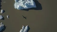 Aerial Of Man Kayaking Through Glaciers In A Jokulsarlon Lake Stock Footage