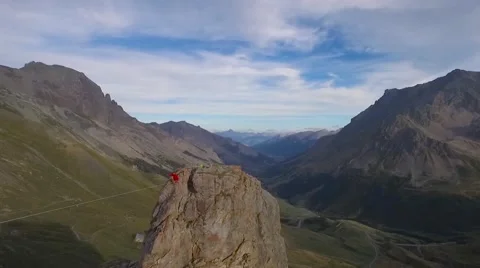 Aerial of man losing is balance while walking on slackline Stock Footage 64345787