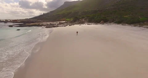 Aerial of Man Walking Alone on Empty Beach, Cape Town Video stock 60114945