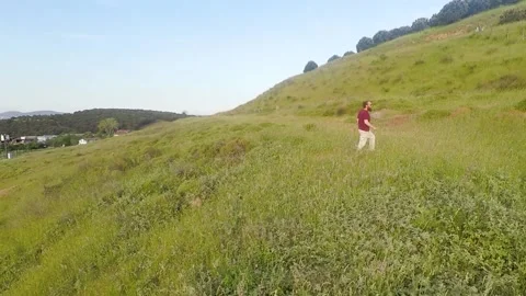 Aerial man walking in fields Stock Footage 197018820