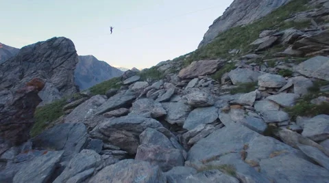 Aerial of man walking on slackline 스톡 동영상 64723764