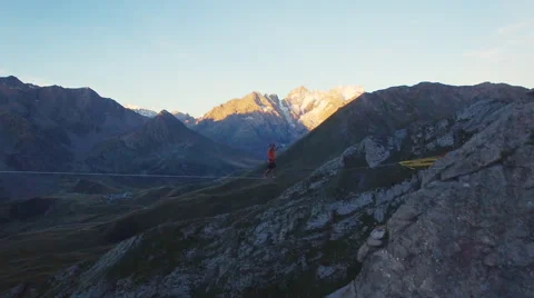 Aerial of man walking on slackline Stock Footage 64723780