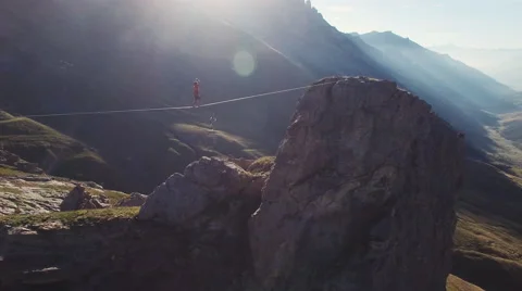 Aerial of man walking on slackline Stock-Footage 64723907