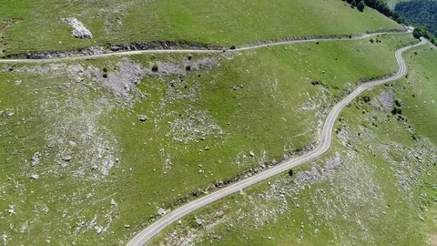 Aerial map of the Maple valley, a mountain road between woods and green meadows Stock-Footage 77411829