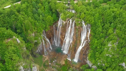 Aerial massive waterfall by lush forest lakes Stock Footage 126465587