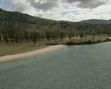 Aerial of Mauritius along tree lined coast. Stock Footage 11309816