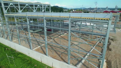 AERIAL Metal storage construction is getting built near wood processing facility Stock Footage 169797470