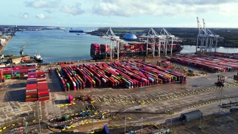 Aerial mid angle cargo ship loading bay on river in Southampton at sunset drone Stock Footage 331126963